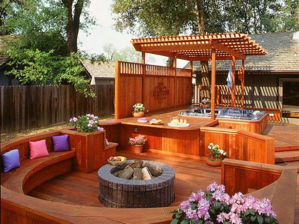 exotic wood deck round fire pit pergola hot tub privacy wall1
